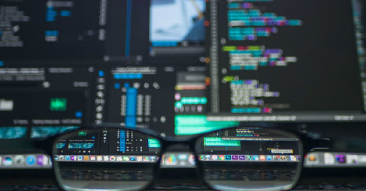 Glasses in front of a computer showing big data